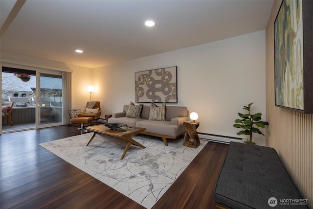 living area with recessed lighting, a baseboard radiator, and wood finished floors