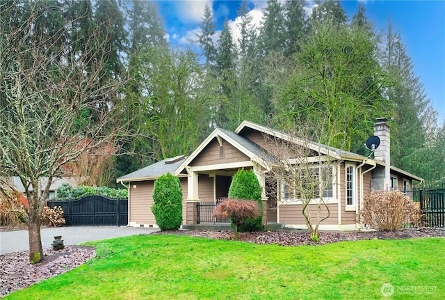 view of front of property featuring fence, driveway, crawl space, a front lawn, and a chimney