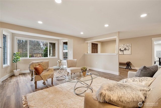 living room with recessed lighting, baseboards, and wood finished floors