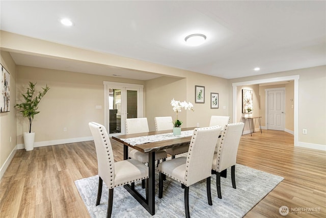 dining room with recessed lighting, light wood-style flooring, and baseboards