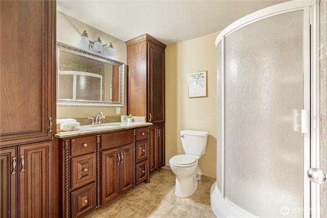 full bath featuring toilet, a stall shower, vanity, tile patterned flooring, and baseboards