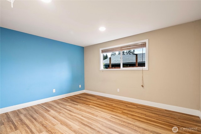 unfurnished room featuring recessed lighting, baseboards, and wood finished floors