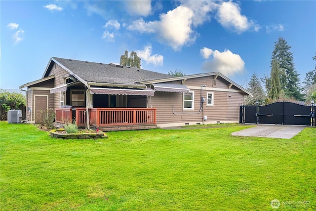 back of property with a gate, a lawn, a deck, and central air condition unit