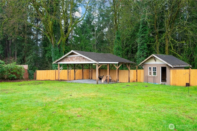 view of yard featuring an outbuilding, a gazebo, and fence