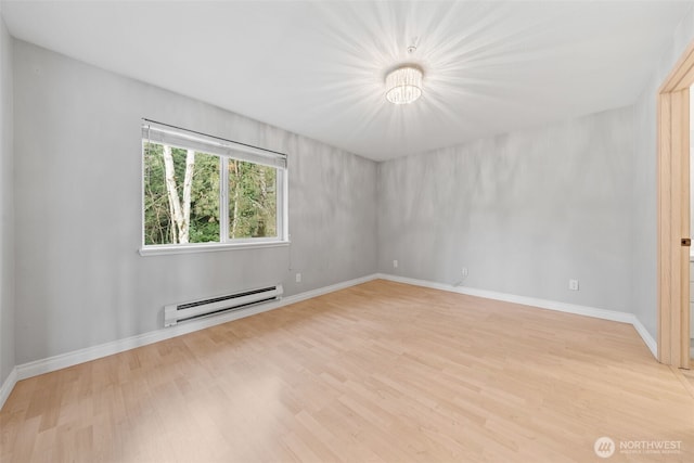 unfurnished room with light wood finished floors, a baseboard radiator, and baseboards