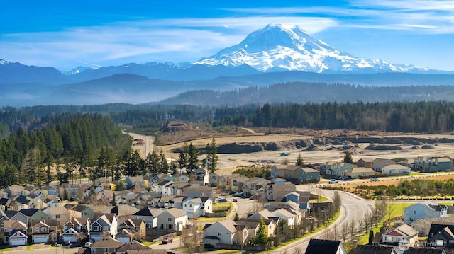 bird's eye view with a residential view, a mountain view, and a wooded view