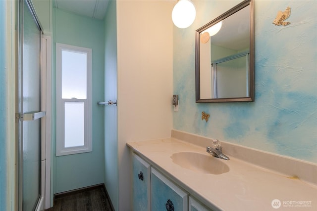 full bath featuring a shower with shower door and vanity