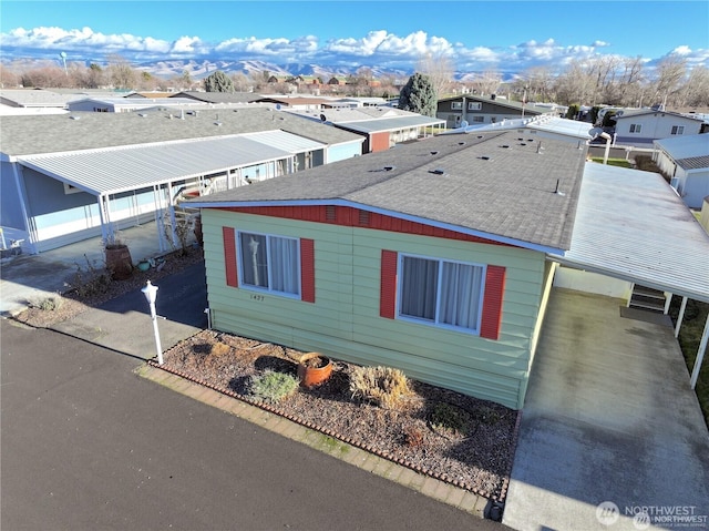 1427 Topaz St, Walla Walla, WA 99362 - view of side of property featuring roof with shingles, a residential view, and an attached carport