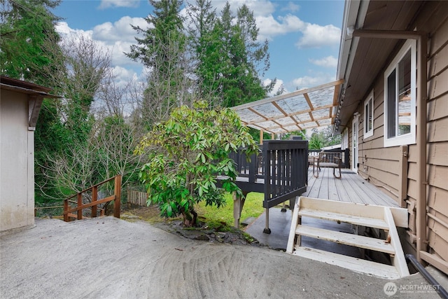 wooden terrace with a patio and a pergola