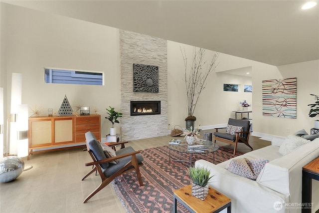 living area with a fireplace and wood finished floors