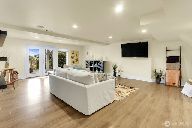 living area featuring visible vents, french doors, wood finished floors, and recessed lighting