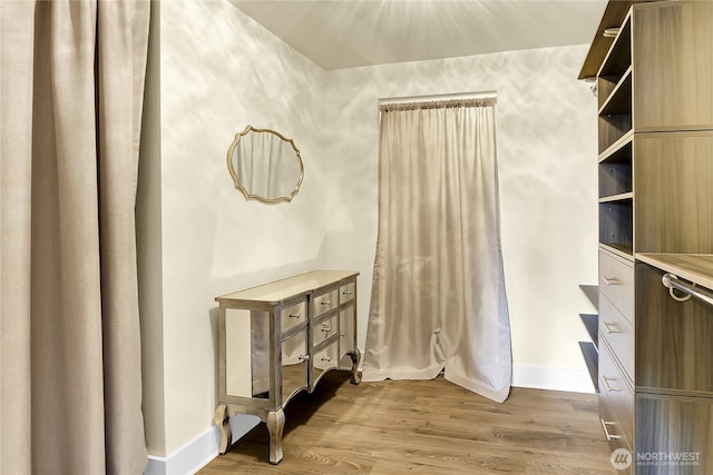 spacious closet with wood finished floors