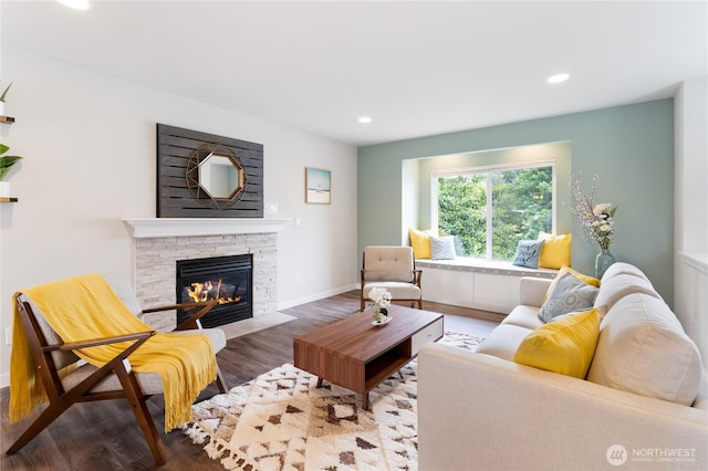 living area featuring a fireplace, baseboards, wood finished floors, and recessed lighting