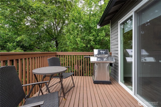 wooden deck with a grill