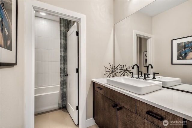 bathroom with tile patterned flooring, tub / shower combination, and vanity