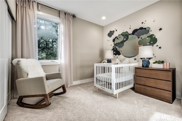 carpeted bedroom featuring recessed lighting, a crib, and baseboards