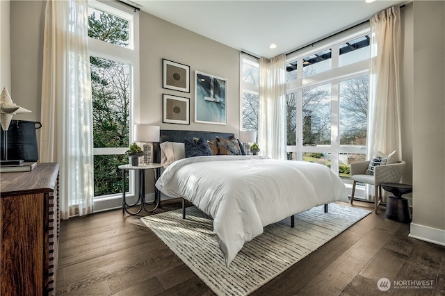 bedroom with dark wood-style floors and baseboards