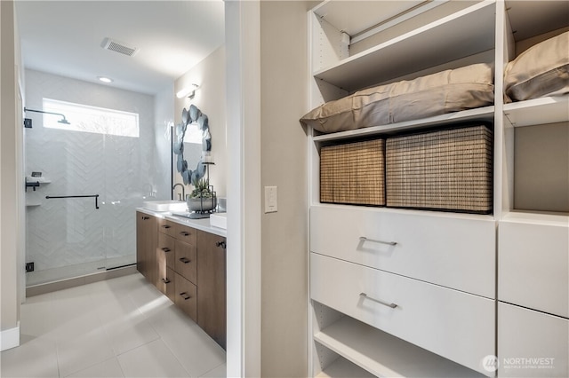 bathroom with visible vents, a shower stall, vanity, and tile patterned floors