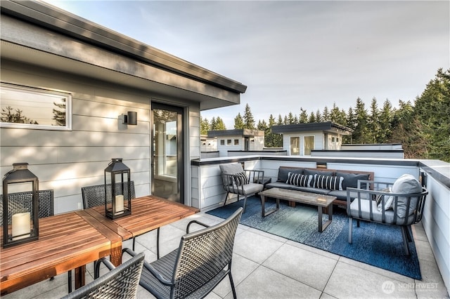 balcony featuring outdoor dining area and outdoor lounge area