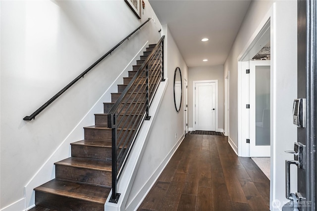 interior space featuring baseboards, hardwood / wood-style floors, stairs, and recessed lighting