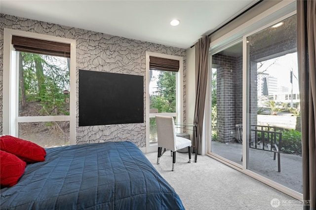 bedroom featuring carpet floors, wallpapered walls, and access to outside