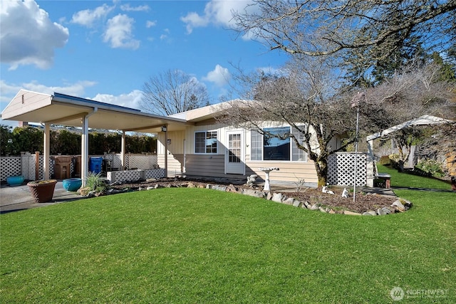 rear view of house with a yard