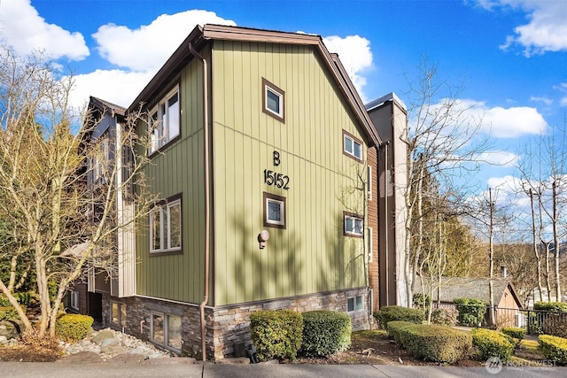 view of side of property with stone siding