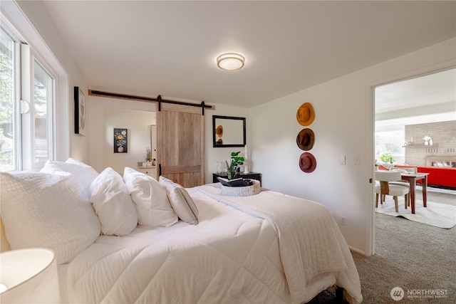 bedroom with carpet floors and a barn door