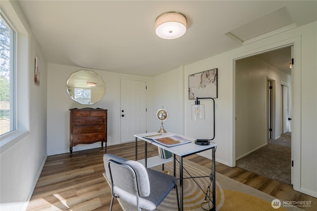 home office with attic access, baseboards, and light wood finished floors