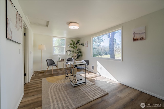 office space featuring attic access, wood finished floors, visible vents, and baseboards