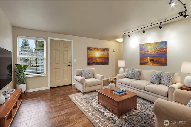 living area with wood finished floors and baseboards