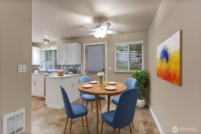 dining area featuring baseboards, visible vents, and a ceiling fan