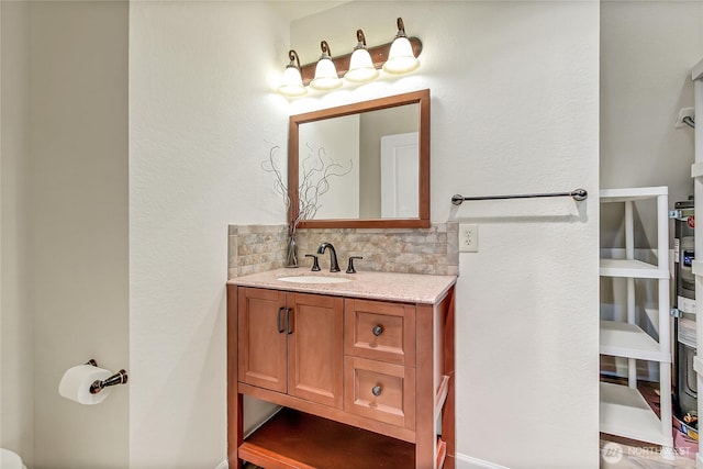 bathroom with tasteful backsplash and vanity