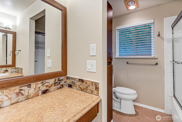 bathroom with toilet, decorative backsplash, vanity, baseboards, and tile patterned floors