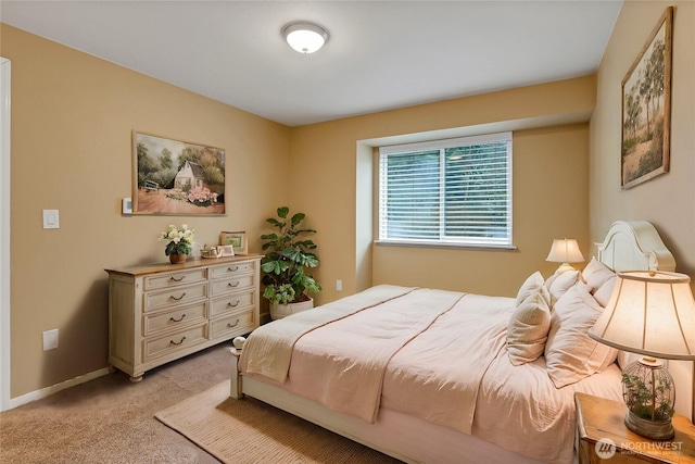 bedroom featuring baseboards and light colored carpet