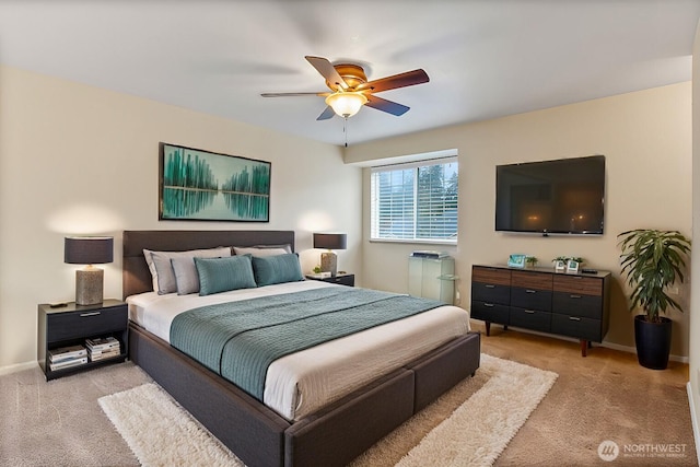 carpeted bedroom with ceiling fan and baseboards