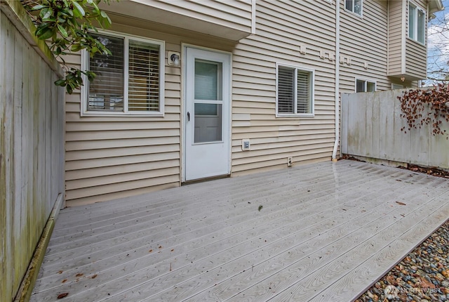 wooden terrace featuring fence