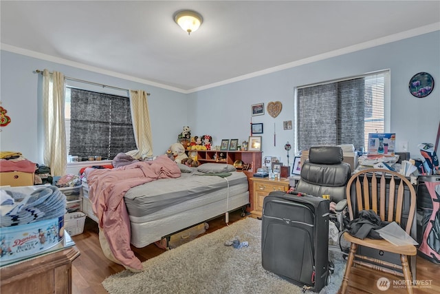 bedroom featuring crown molding and wood finished floors