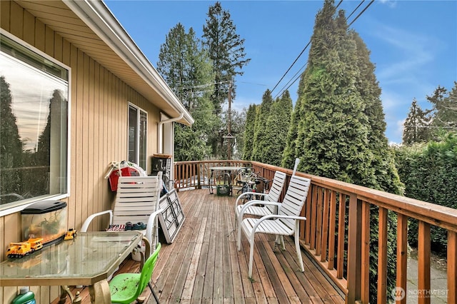 wooden deck featuring outdoor dining area