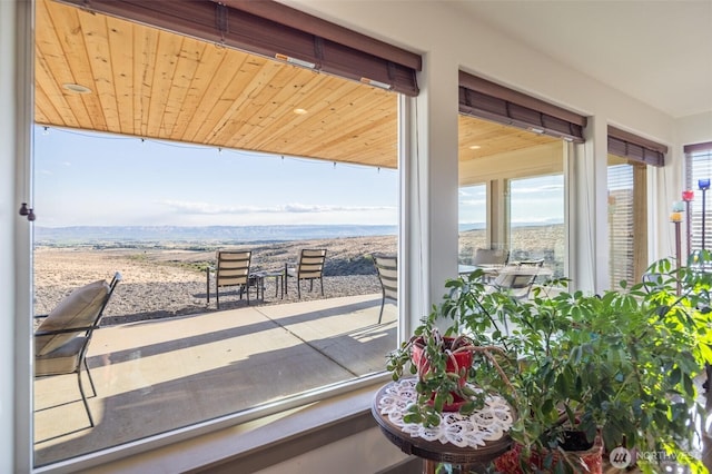 interior space featuring wood ceiling and a mountain view