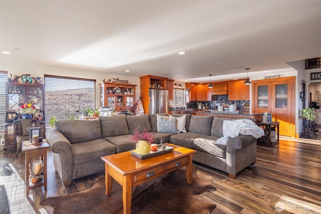 living area with dark wood finished floors and recessed lighting