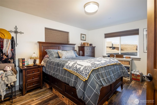 bedroom with dark wood-style flooring