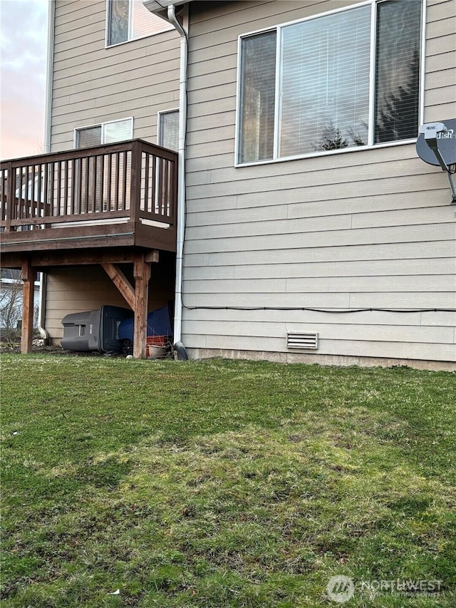 exterior space with crawl space and a lawn