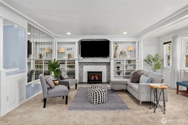 sitting room with carpet, crown molding, a fireplace, a decorative wall, and recessed lighting