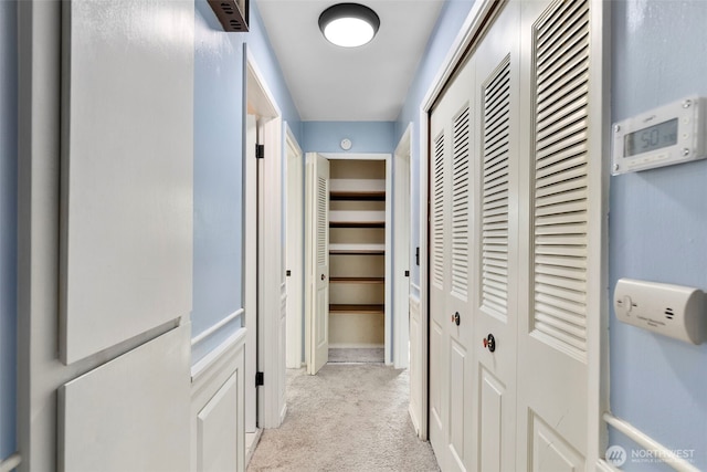 corridor with light colored carpet