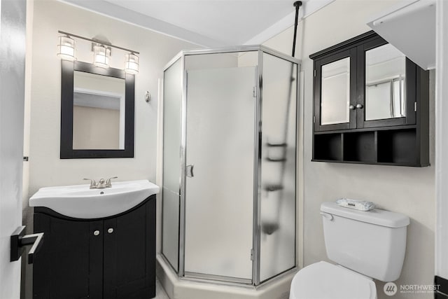 full bathroom featuring toilet, a shower stall, and vanity