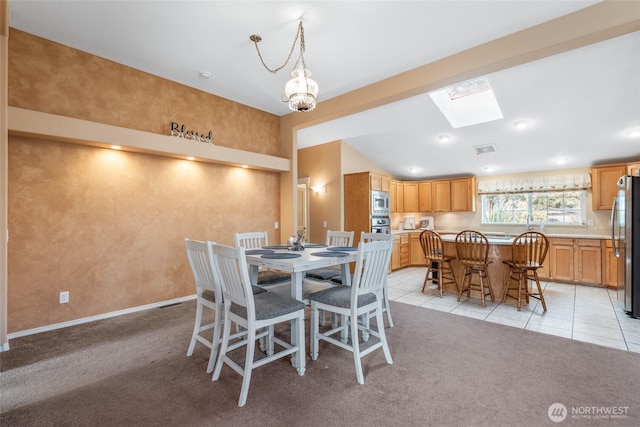 dining area featuring light tile patterned floors, baseboards, visible vents, light colored carpet, and lofted ceiling with skylight