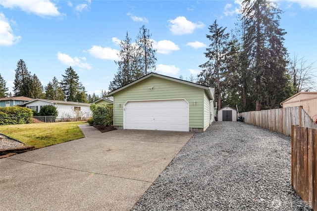 garage with a storage unit and fence