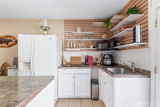 kitchen featuring light tile patterned floors, open shelves, white cabinets, a sink, and black appliances