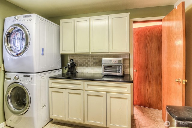 laundry room with laundry area, stacked washing maching and dryer, and stone finish flooring